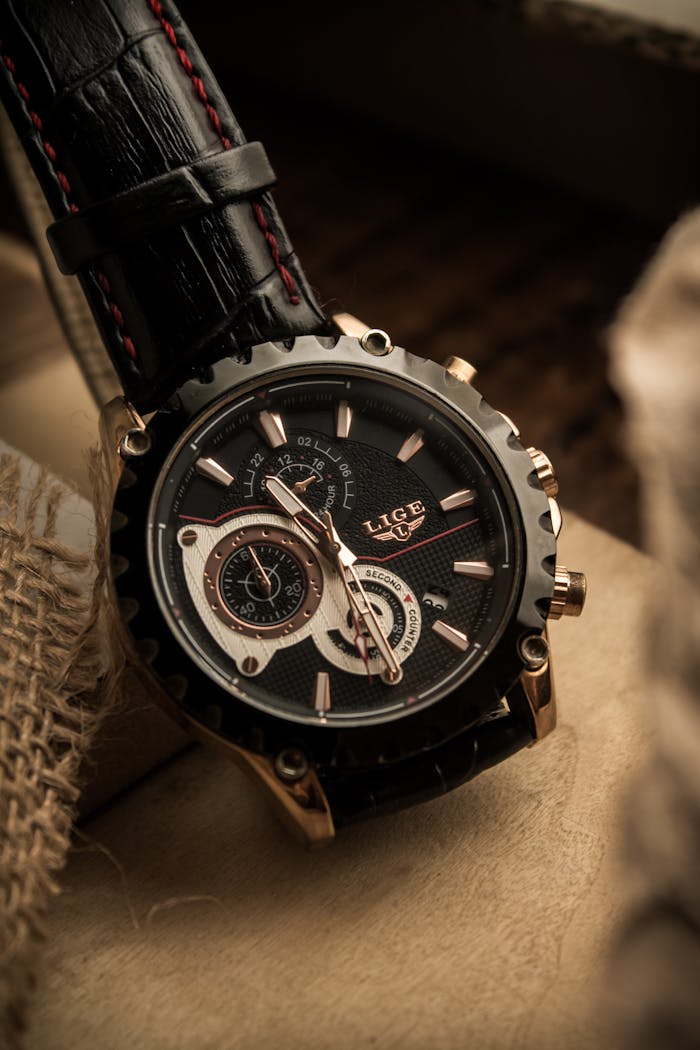 Close-up of a stylish wristwatch with a black leather strap and intricate dial design.